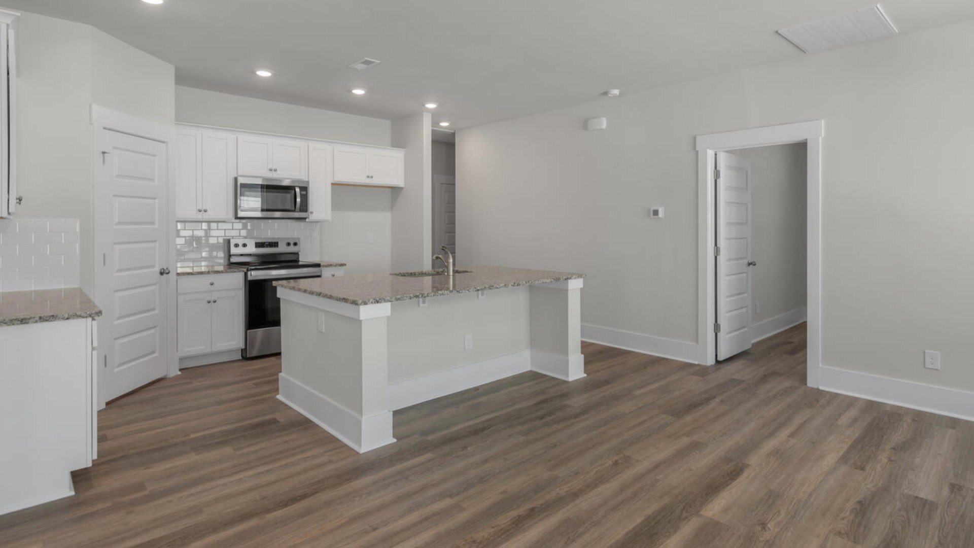The kitchen features quartz countertops, and stainless steel appliances, which are sure to both turn heads and make meal prep easy. You’ll never be too far from the action with the living and dining area right there.
