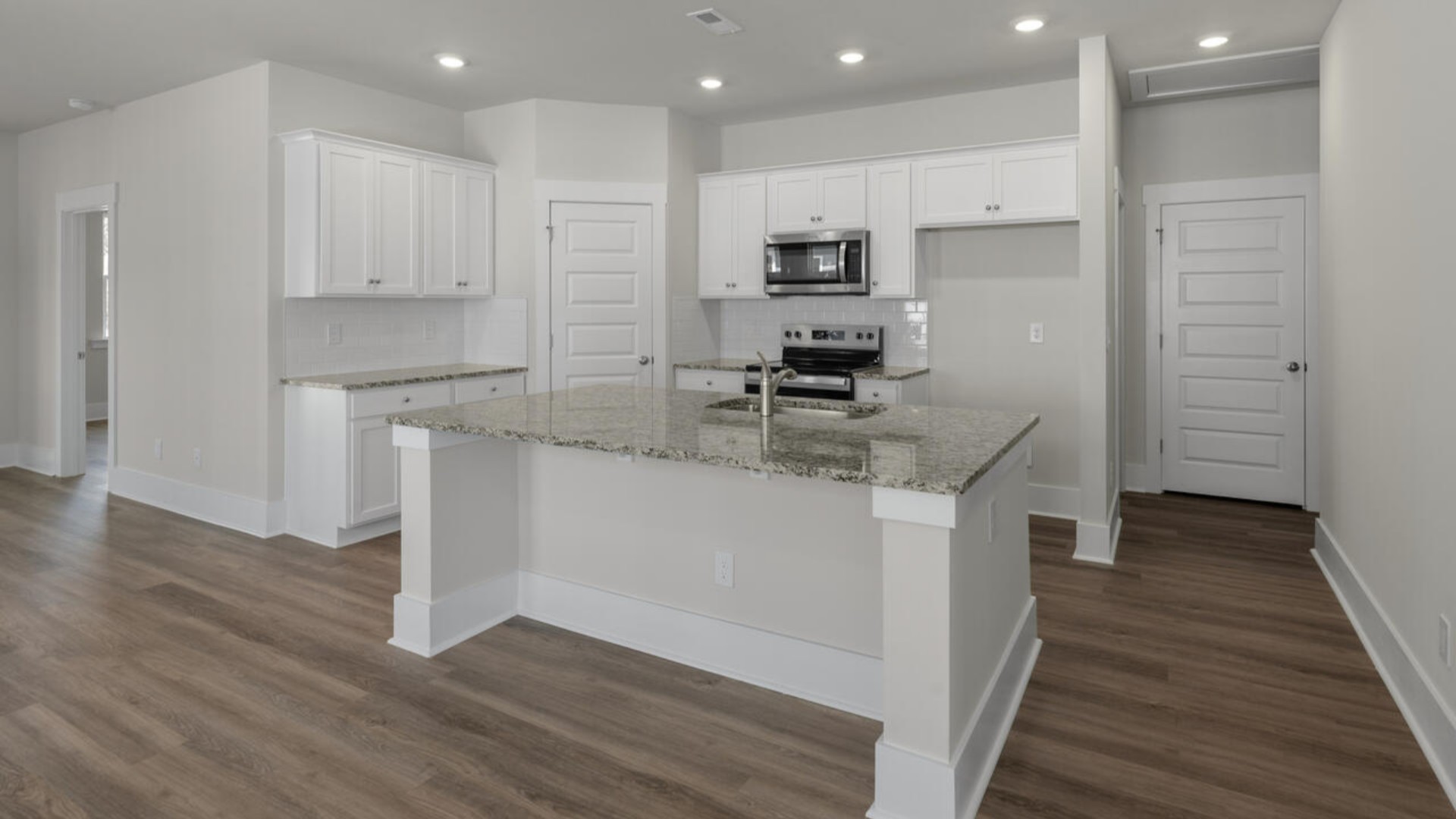 The kitchen features quartz countertops, and stainless steel appliances, which are sure to both turn heads and make meal prep easy. You’ll never be too far from the action with the living and dining area right there.