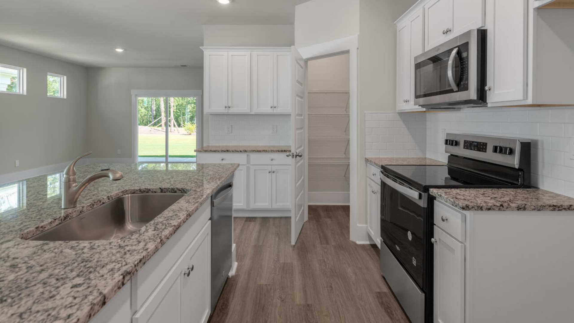 The kitchen features quartz countertops, and stainless steel appliances, which are sure to both turn heads and make meal prep easy. You’ll never be too far from the action with the living and dining area right there.