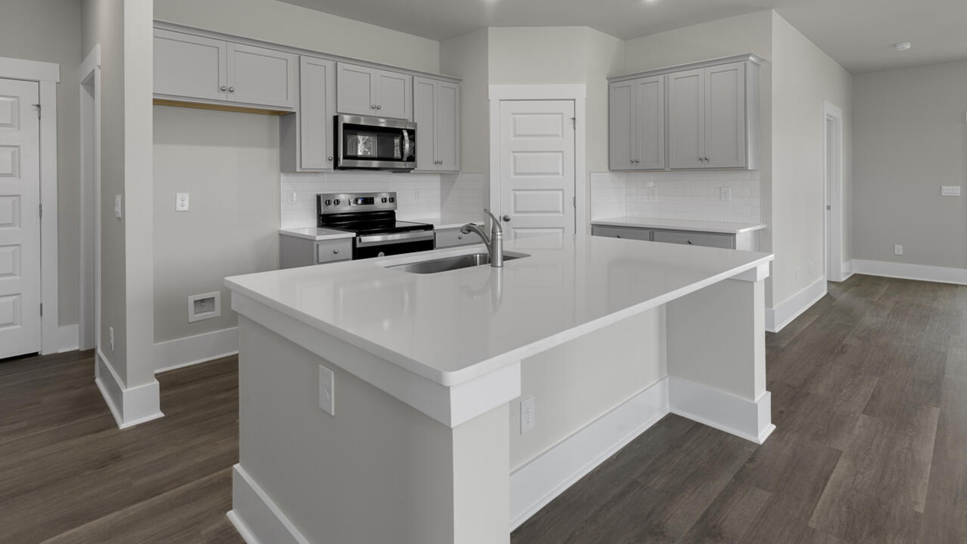 The kitchen features quartz countertops, and stainless steel appliances, which are sure to both turn heads and make meal prep easy. You’ll never be too far from the action with the living and dining area right there.
