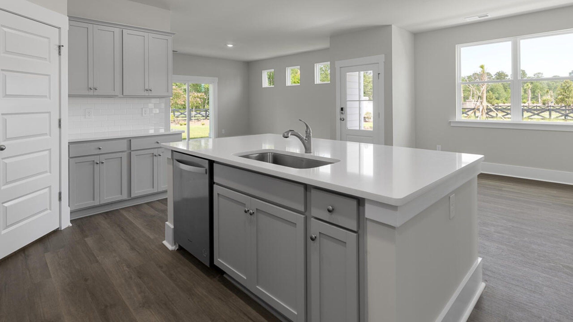 The kitchen features quartz countertops, and stainless steel appliances, which are sure to both turn heads and make meal prep easy. You’ll never be too far from the action with the living and dining area right there.