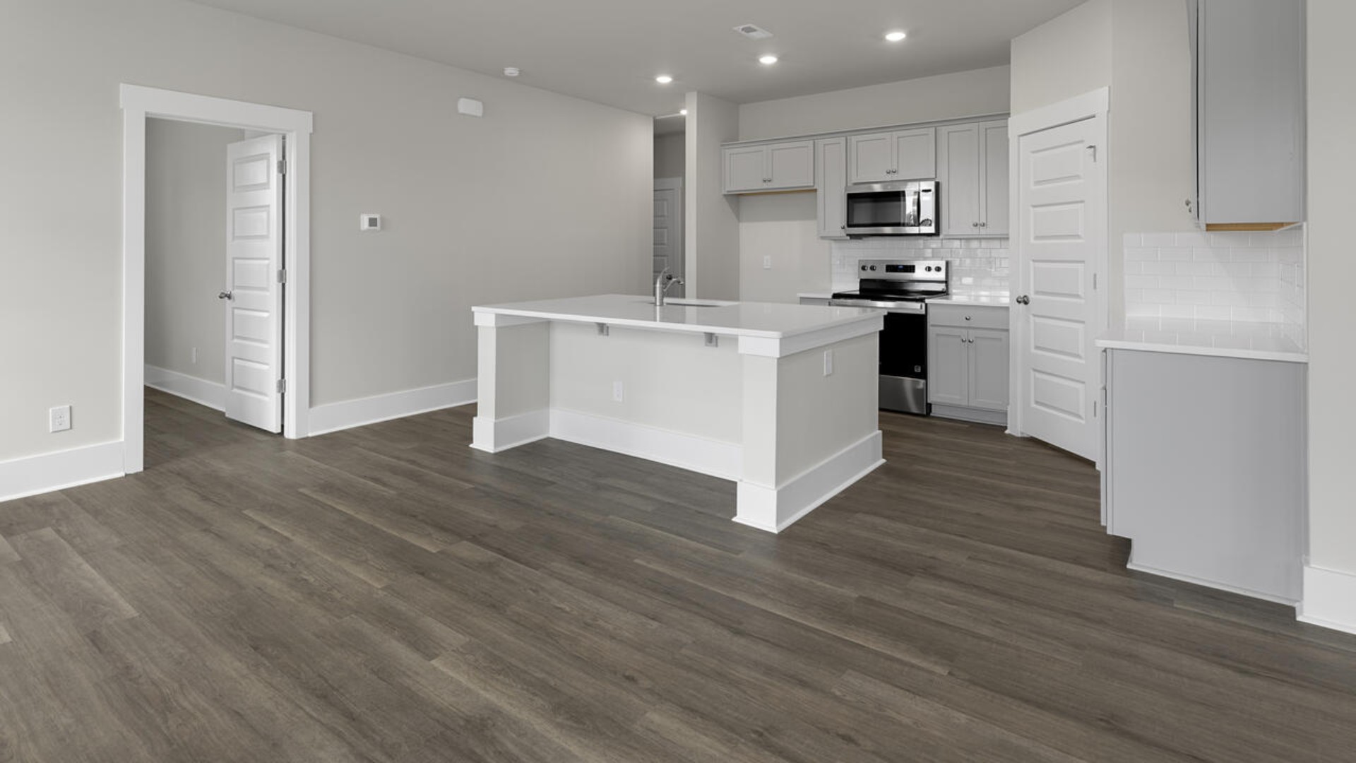 The kitchen features quartz countertops, and stainless steel appliances, which are sure to both turn heads and make meal prep easy. You’ll never be too far from the action with the living and dining area right there.
