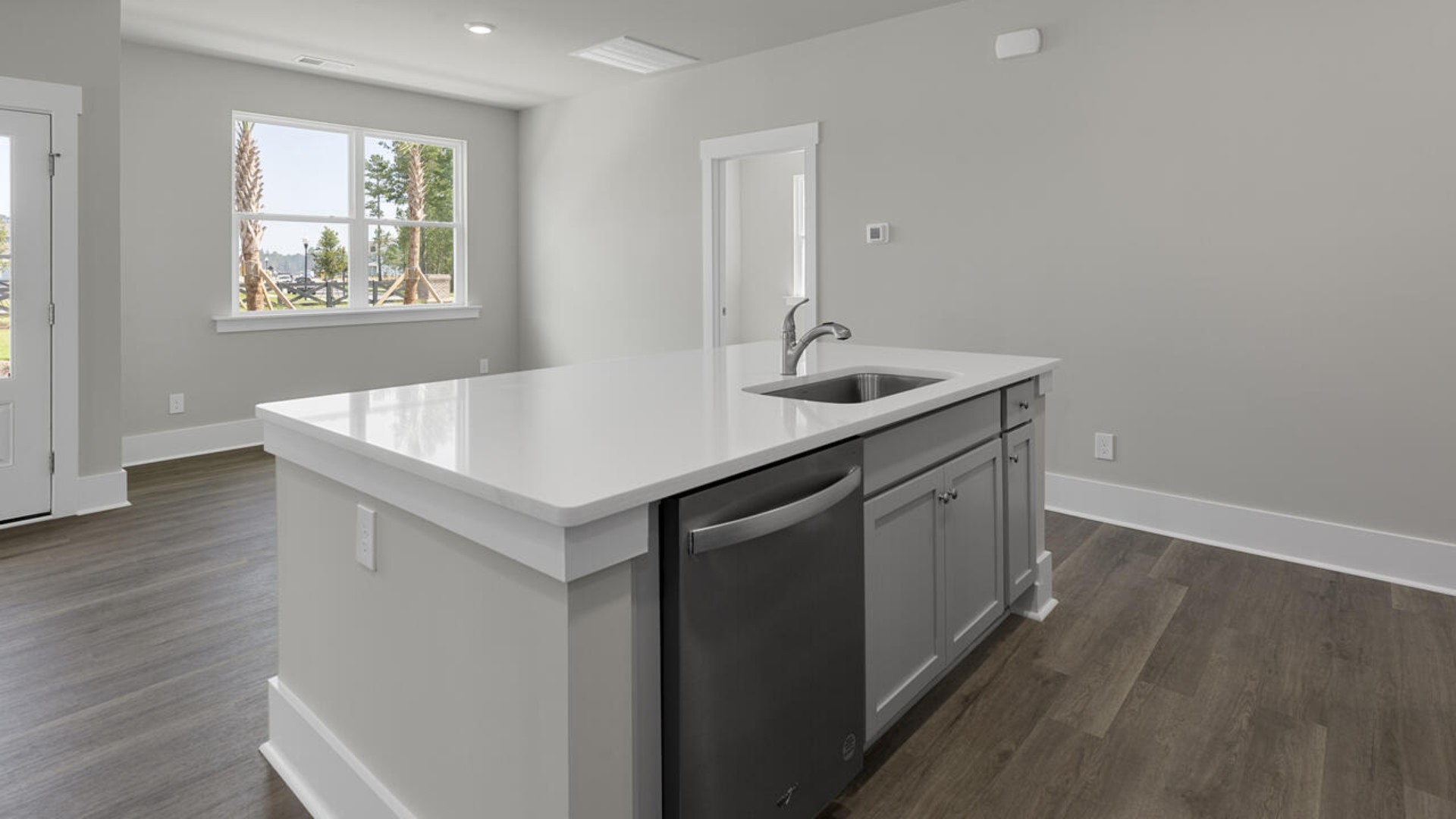 The kitchen features quartz countertops, and stainless steel appliances, which are sure to both turn heads and make meal prep easy. You’ll never be too far from the action with the living and dining area right there.