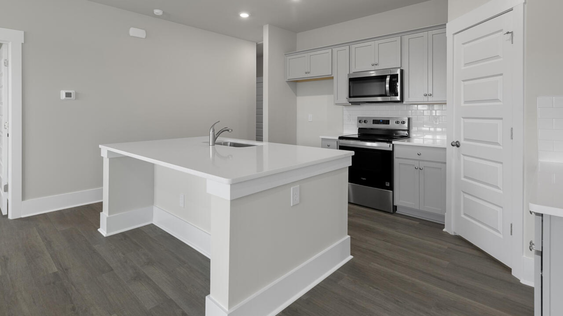 The kitchen features quartz countertops, and stainless steel appliances, which are sure to both turn heads and make meal prep easy. You’ll never be too far from the action with the living and dining area right there.