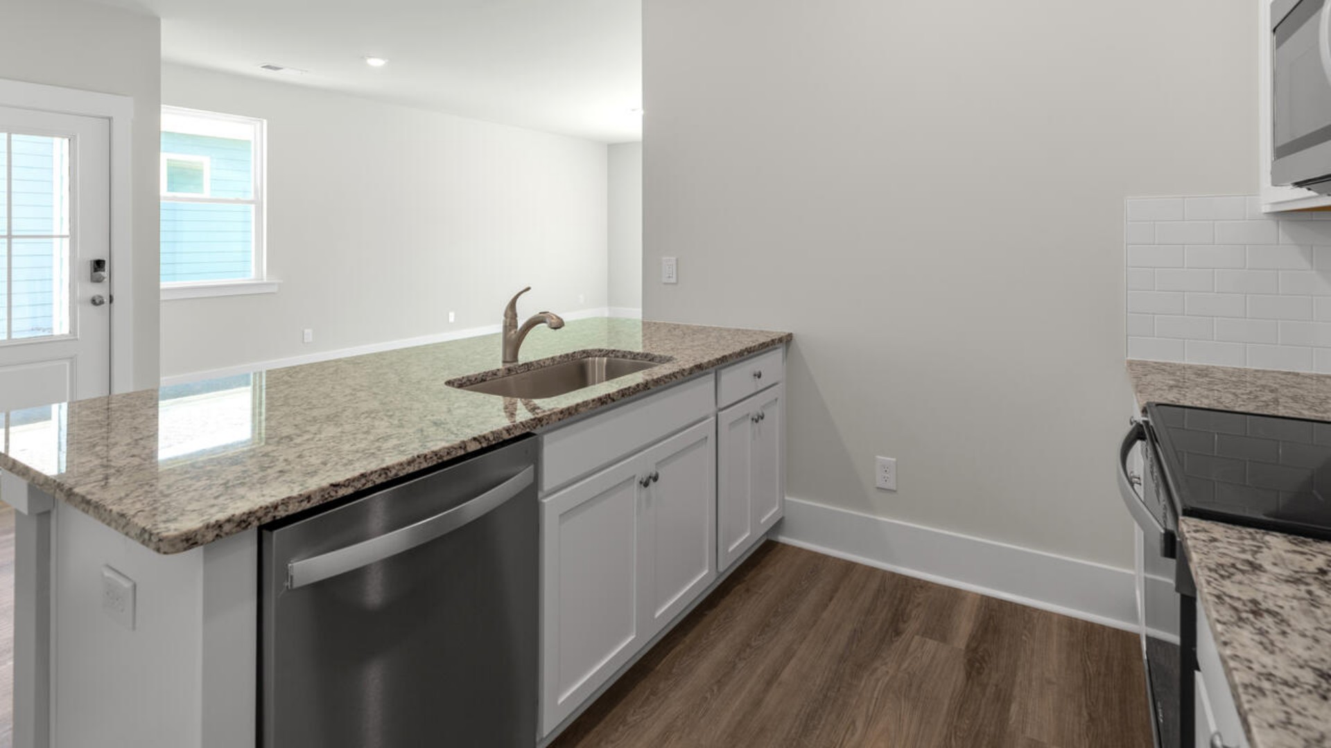 The open-concept layout seamlessly connects the kitchen, dining, and living areas making it ideal for entertaining or everyday relaxation. The kitchen and bathrooms boast elegant granite countertops for both durability and style.