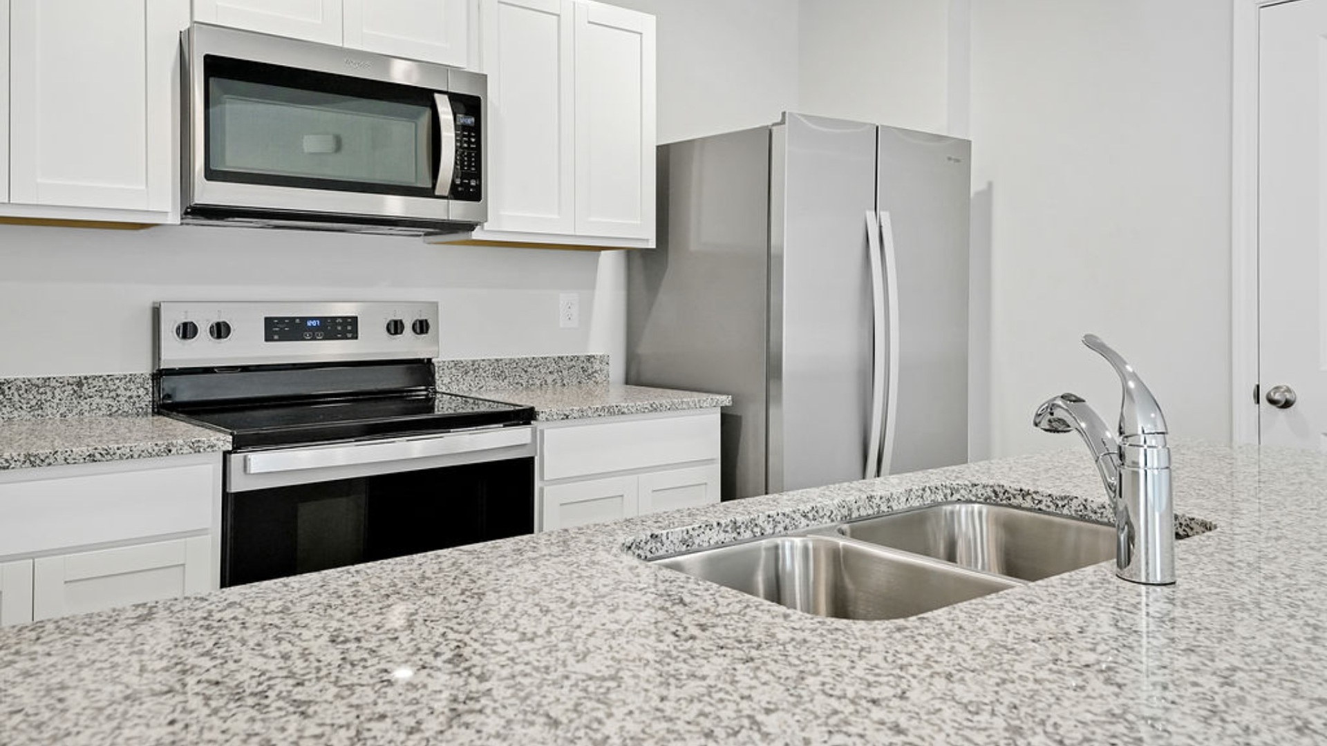 The kitchen features granite countertops, and stainless-steel appliances, which are sure to both turn heads and make meal prep easy. You’ll never be too far from the action with the living and dining area right there.