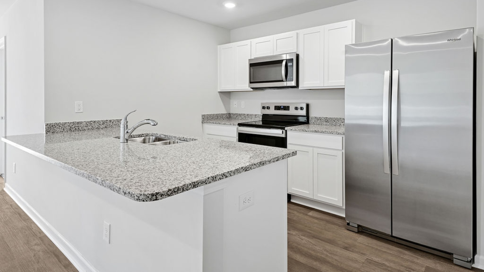 The kitchen features granite countertops, and stainless-steel appliances, which are sure to both turn heads and make meal prep easy. You’ll never be too far from the action with the living and dining area right there.