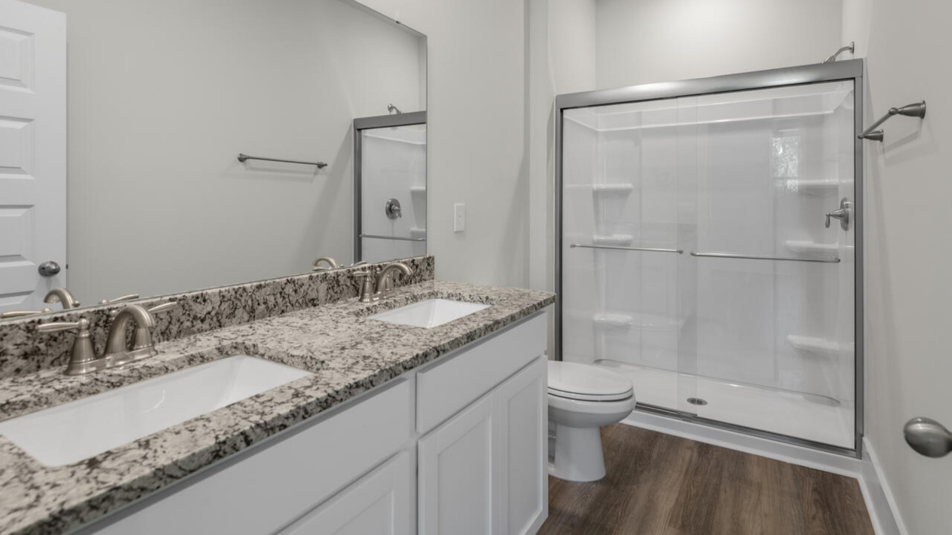 The primary bedroom has its own attached bathroom that features a walk-in closet and all the space you need to get ready in the