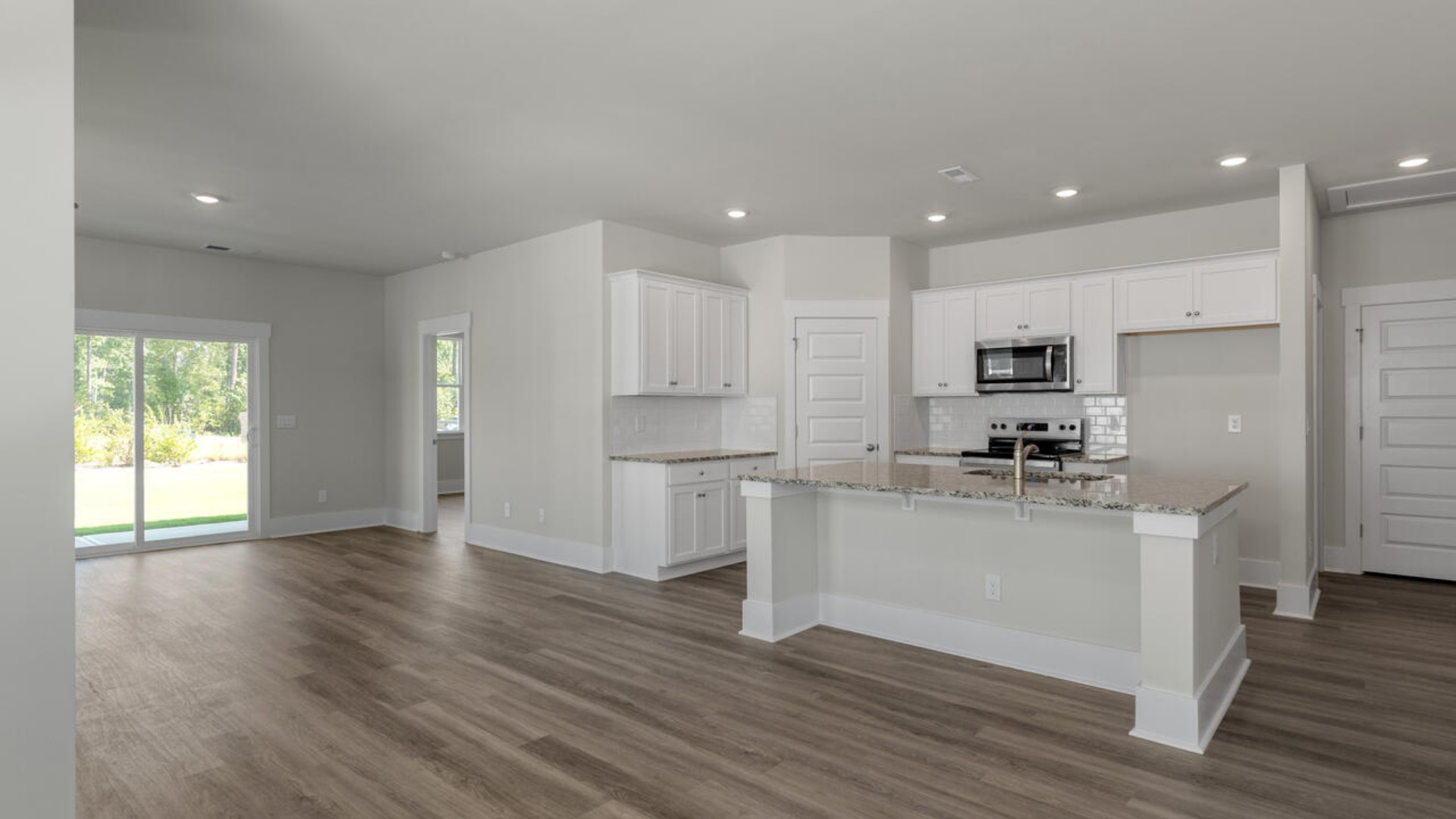 The kitchen features granite countertops, and stainless-steel appliances, which are sure to both turn heads and make meal prep easy. You’ll never be too far from the action with the living and dining area right there.