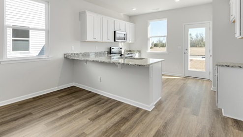 The kitchen features beautiful cabinets, granite countertops, and stainless steel appliances, which are sure to both turn heads and make meal prep easy.