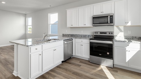 The kitchen features beautiful cabinets, granite countertops, and stainless steel appliances, which are sure to both turn heads and make meal prep easy.