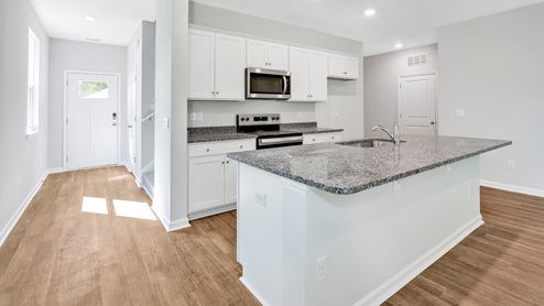The kitchen features beautiful cabinets, granite countertops, and stainless steel appliances, which are sure to both turn heads and make meal prep easy. You’ll never be too far from the action with the living and dining area right there.