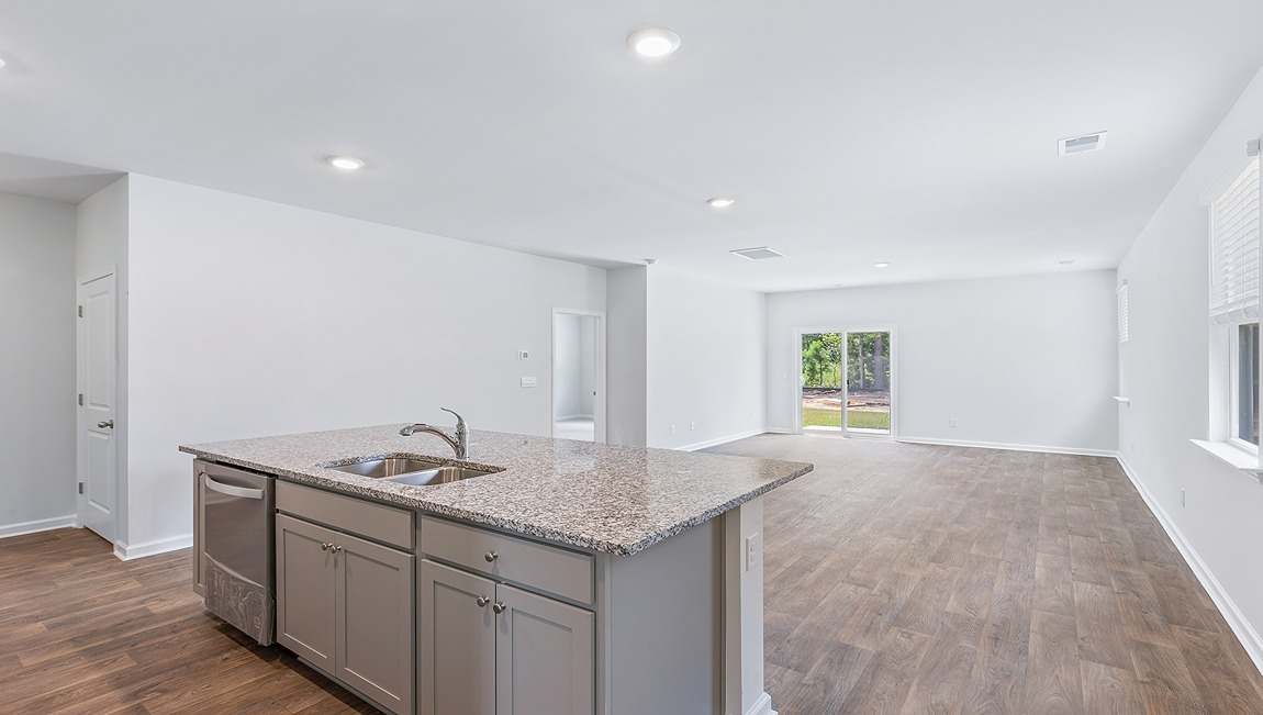 This beautiful kitchen features granite counters, stainless steel appliances, a large kitchen island with room for 4 counter height barstools and there's a pantry too. You’ll never be too far from the action with the living and dining area right there.