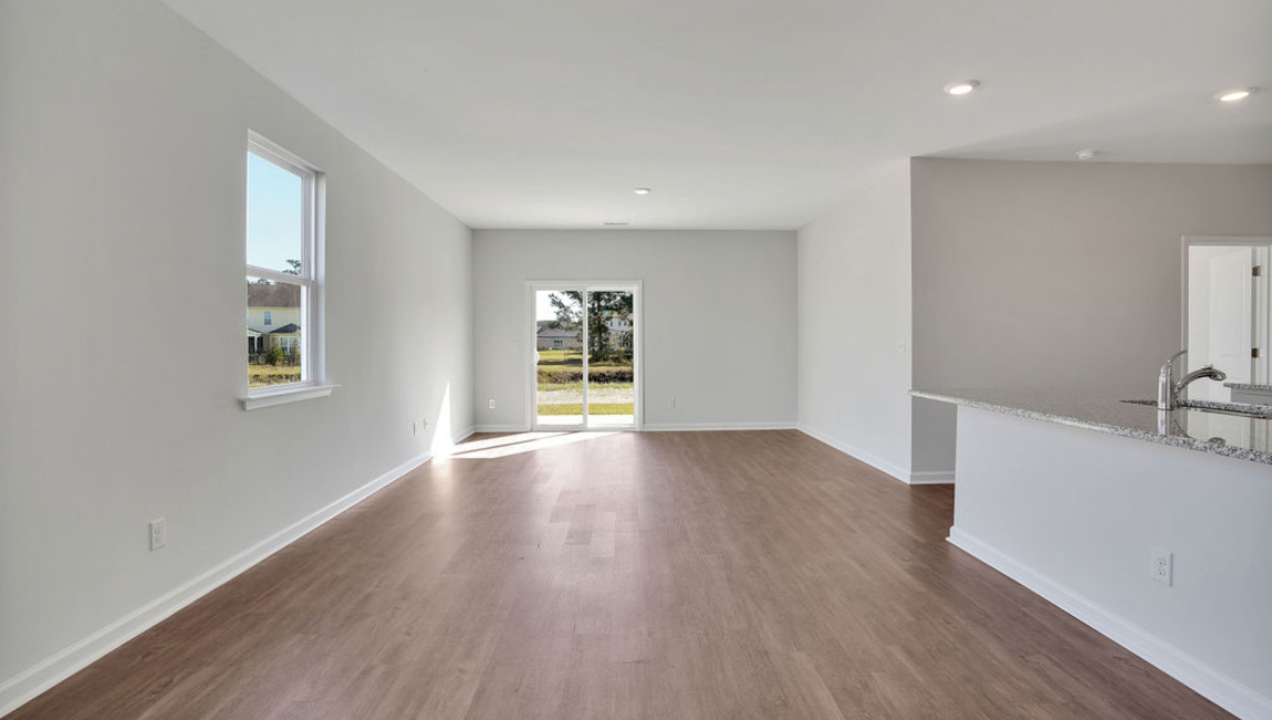 The chef’s kitchen has modern stainless steel appliances, granite countertops, ample cabinet space, a walk-in pantry, and a breakfast bar, perfect for cooking and casual dining. Adjacent to the kitchen is a bedroom, providing privacy and comfort.