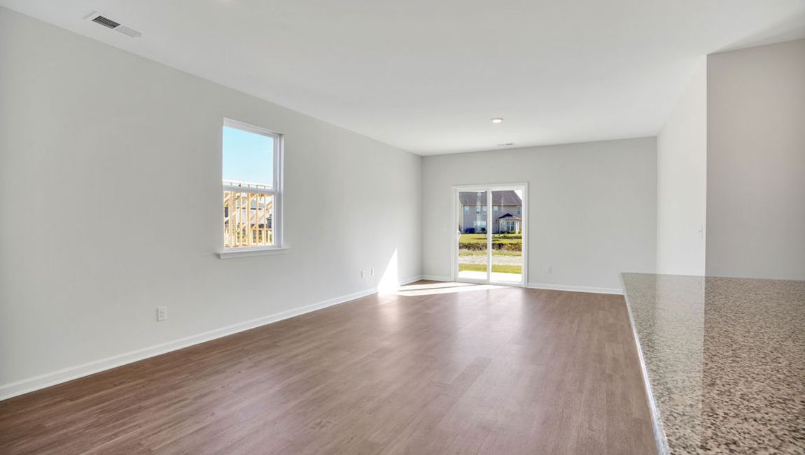 The chef’s kitchen has modern stainless steel appliances, granite countertops, ample cabinet space, a walk-in pantry, and a breakfast bar, perfect for cooking and casual dining. Adjacent to the kitchen is a bedroom, providing privacy and comfort.