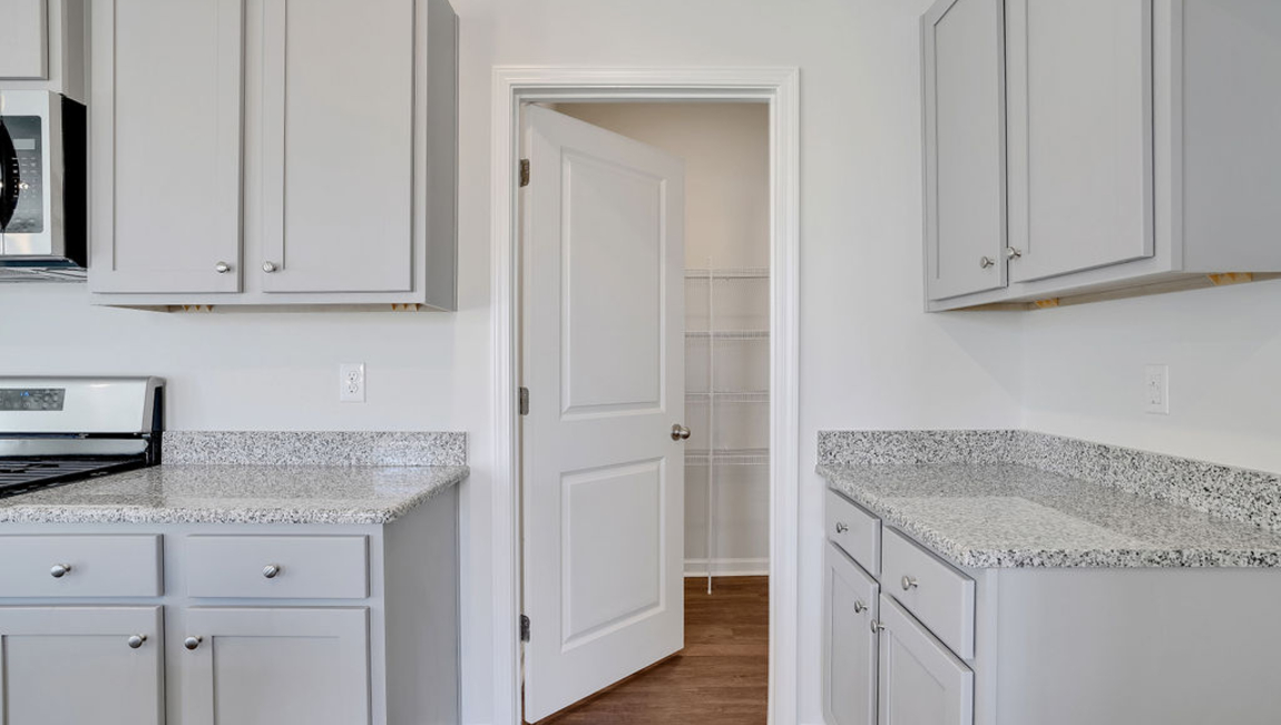 The home features a primary suite with a walk-in closet and an en suite bathroom featuring a shower with dual vanities. The additional three bathrooms are spacious and have access to a secondary bathroom.