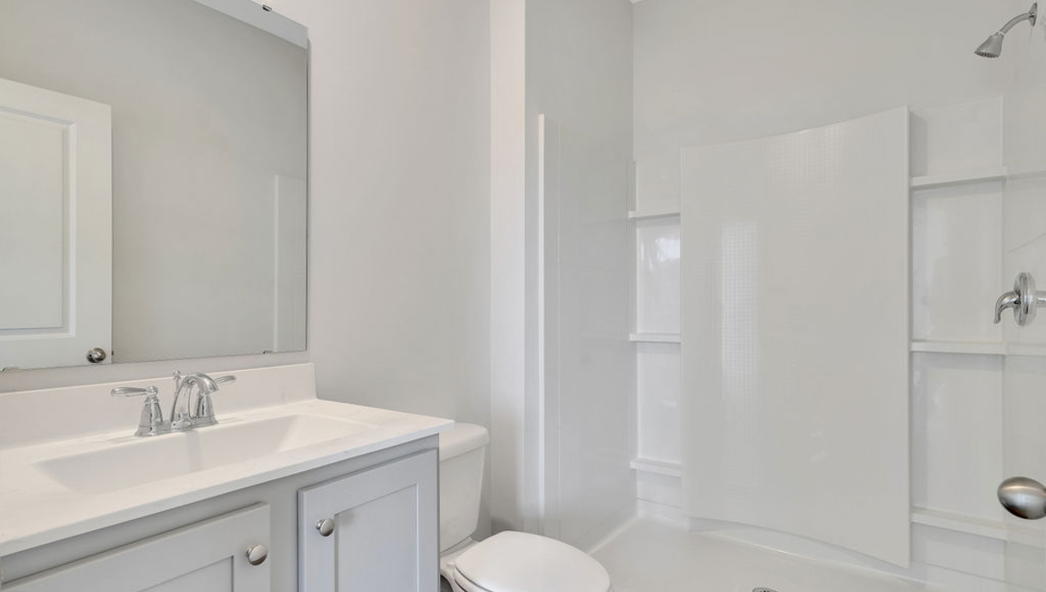 The home features a primary suite with a walk-in closet and an en suite bathroom featuring a shower with dual vanities. The additional three bathrooms are spacious and have access to a secondary bathroom.
