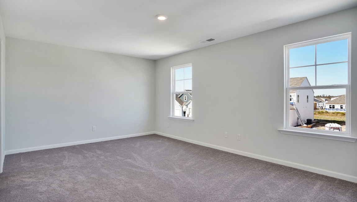 The home features a primary suite with a walk-in closet and an en suite bathroom featuring a shower with dual vanities. The additional three bathrooms are spacious and have access to a secondary bathroom.