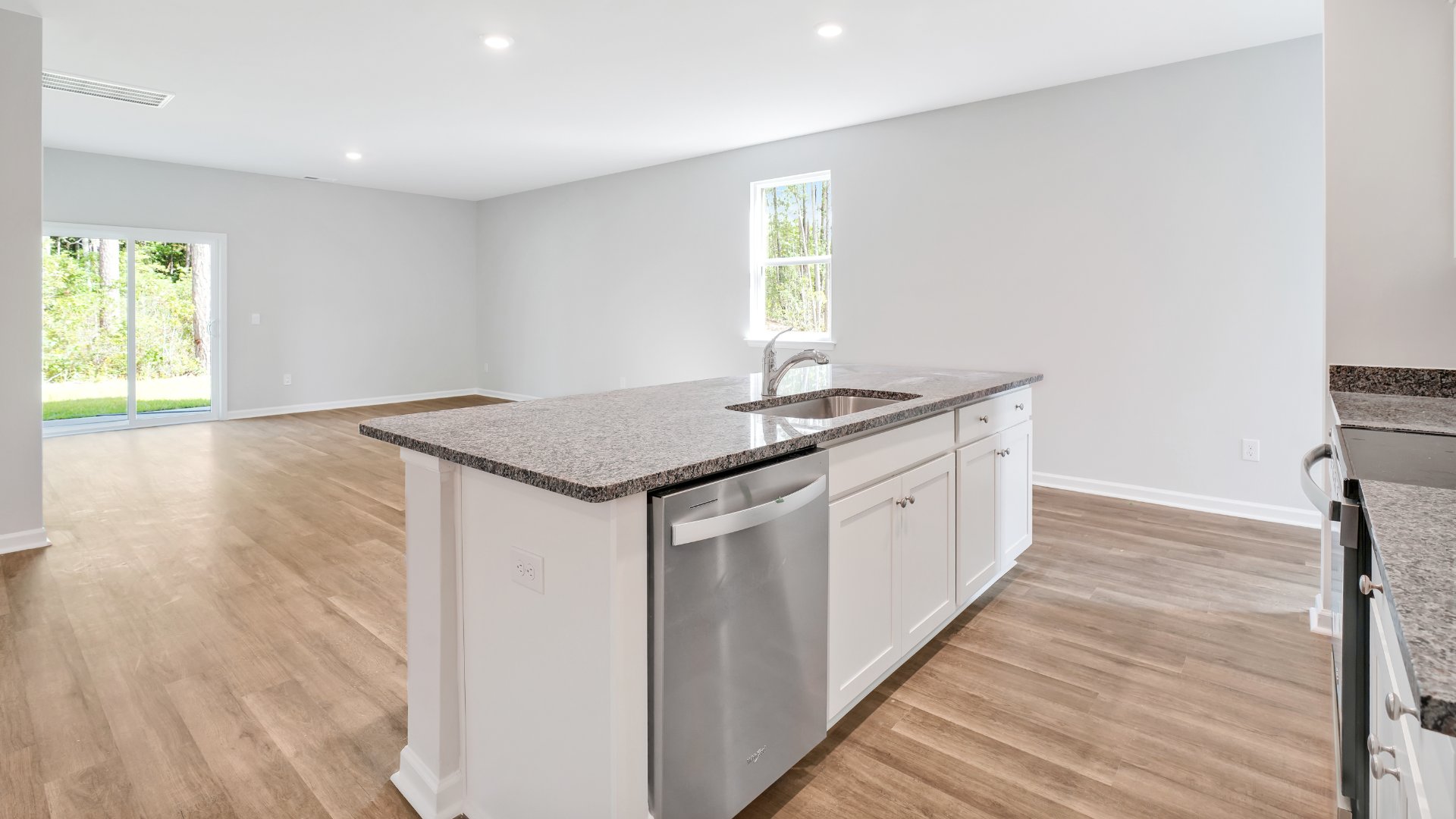 The kitchen features beautiful cabinets, granite countertops, and stainless steel appliances, which are sure to both turn heads and make meal prep easy. You’ll never be too far from the action with the living and dining area right there.