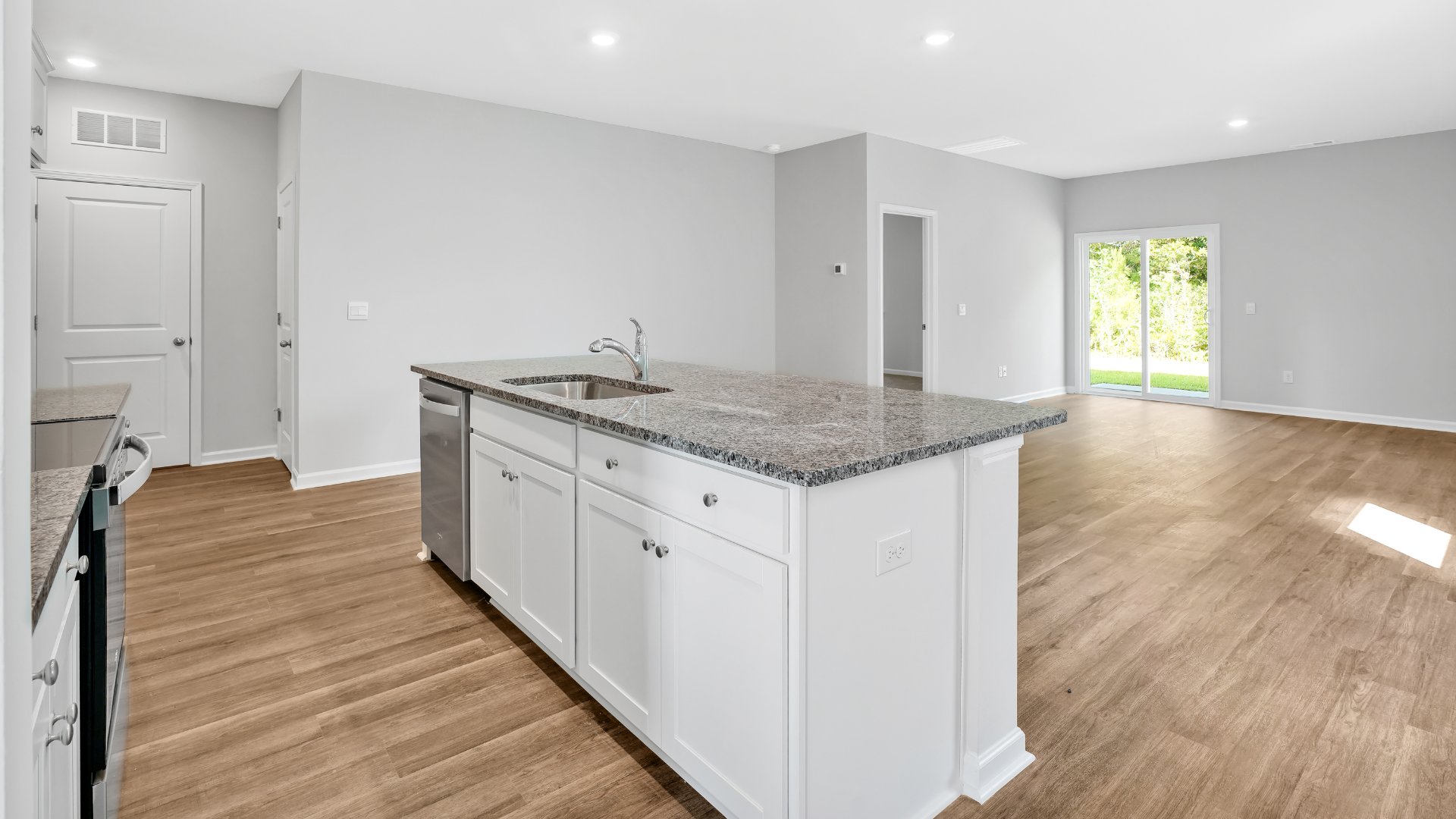 The kitchen features beautiful cabinets, granite countertops, and stainless steel appliances, which are sure to both turn heads and make meal prep easy. You’ll never be too far from the action with the living and dining area right there.