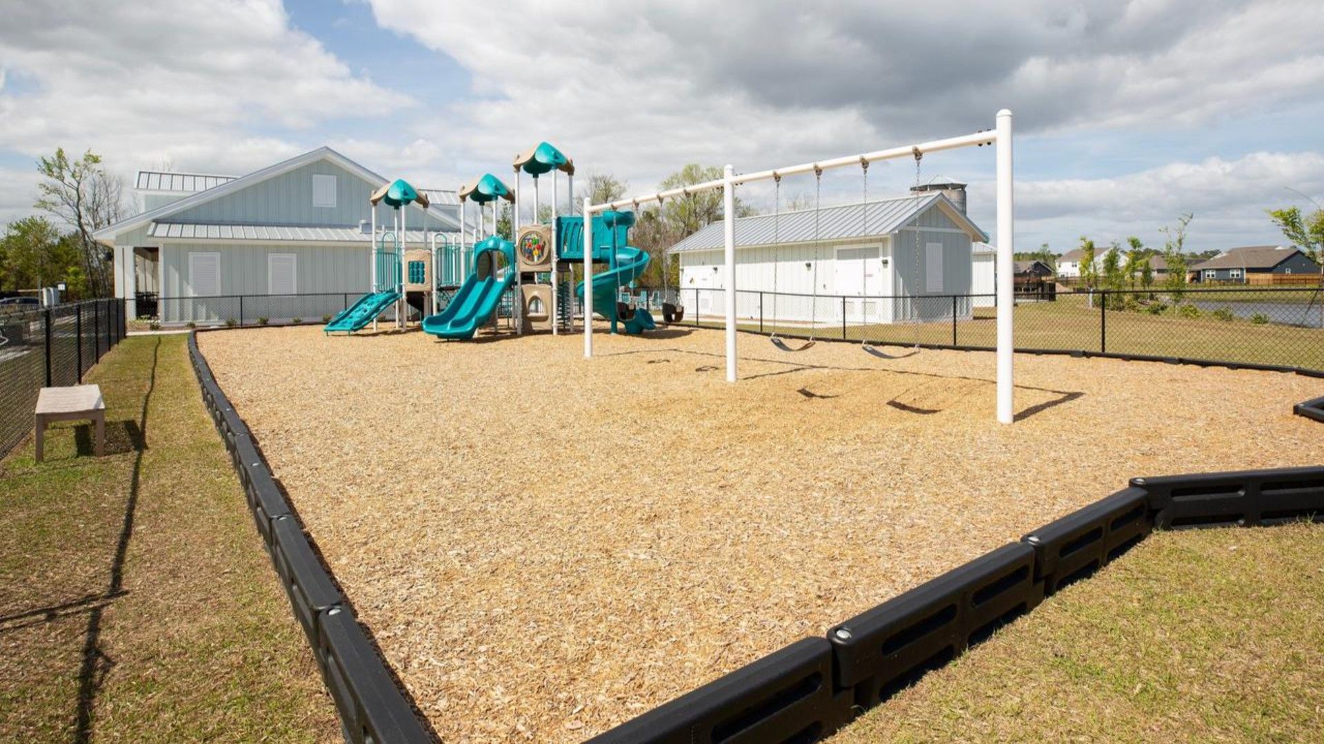 The amenity center that includes a swimming pool, multi-sport court, splashpad, playground, and fire pit, ensuring a well-rounded and enjoyable living experience.