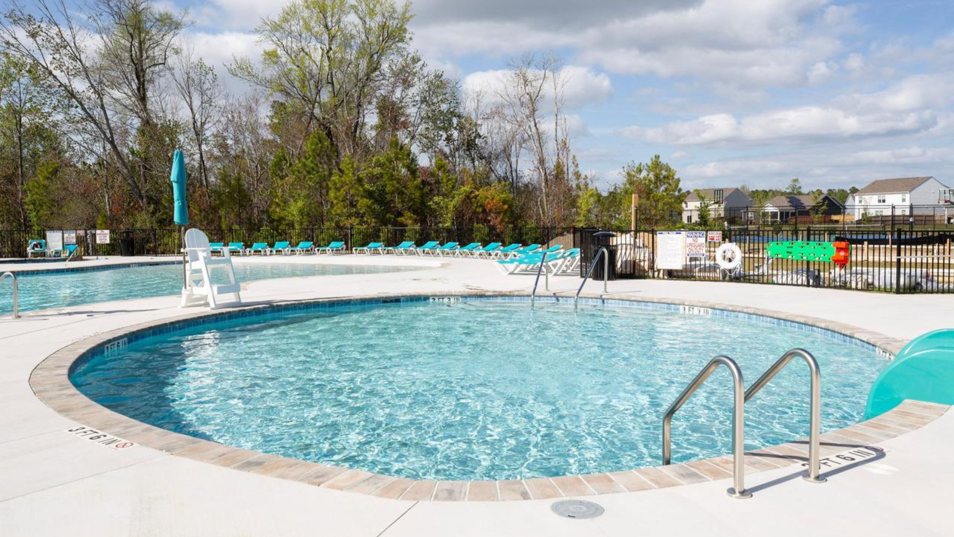 The amenity center that includes a swimming pool, multi-sport court, splashpad, playground, and fire pit, ensuring a well-rounded and enjoyable living experience.