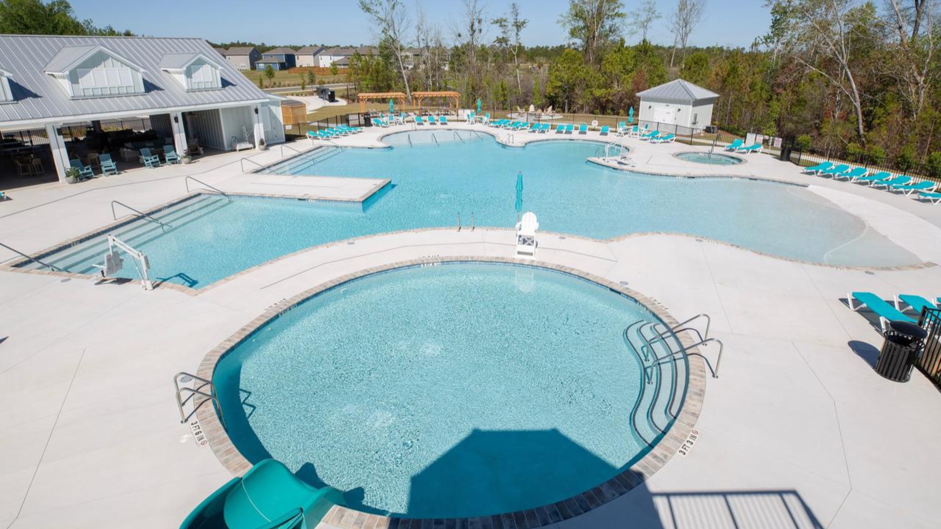 The amenity center that includes a swimming pool, multi-sport court, splashpad, playground, and fire pit, ensuring a well-rounded and enjoyable living experience.
