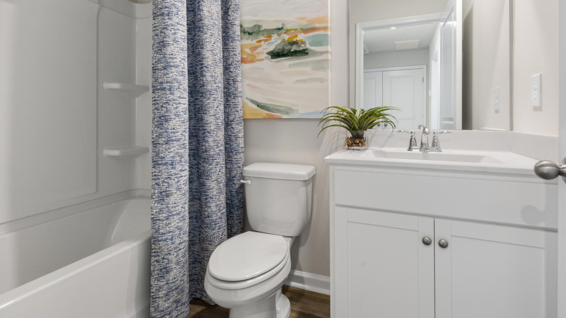 It also includes two additional bedrooms, a shared bathroom, and a laundry room for convenience.