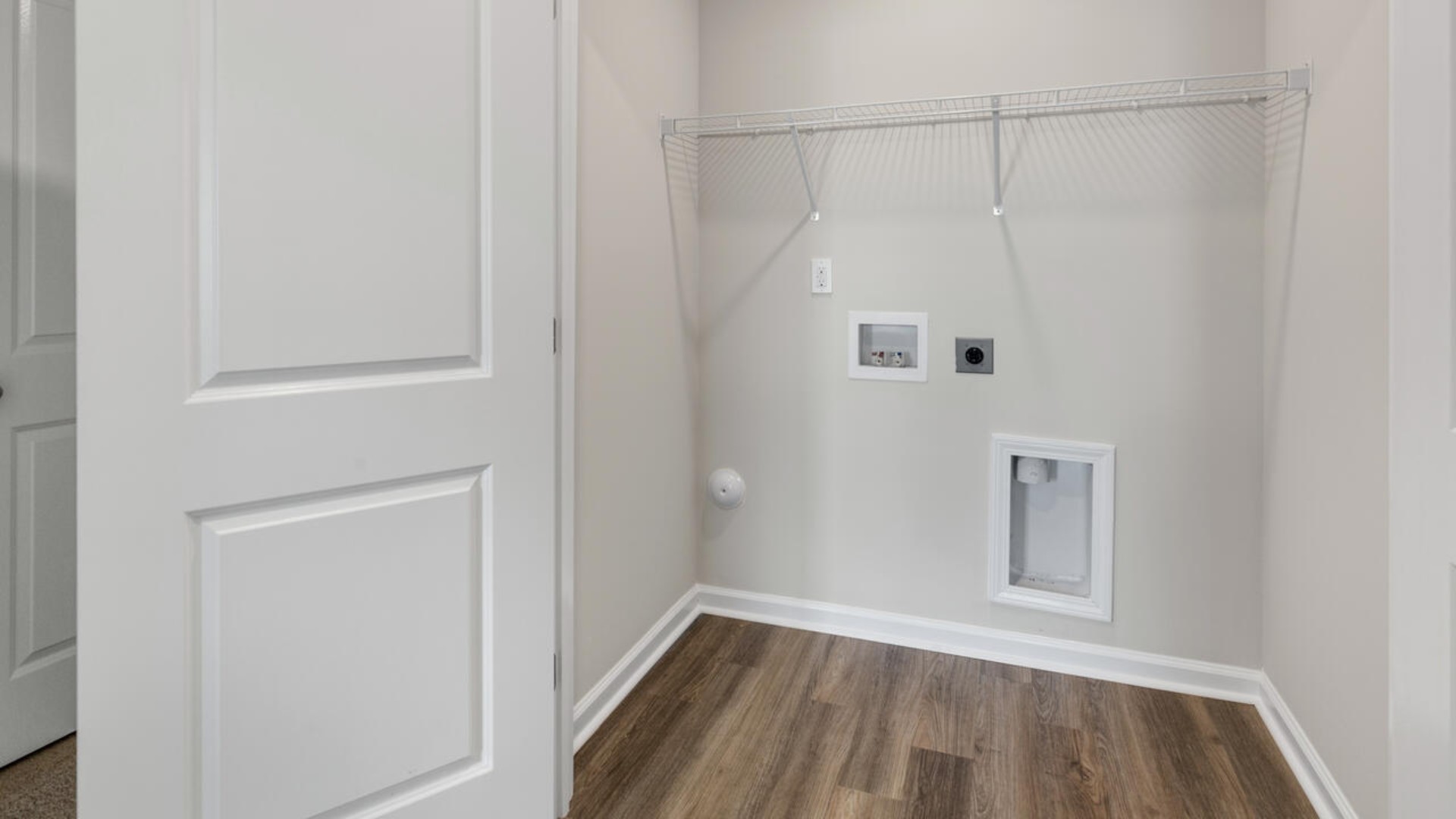 It also includes two additional bedrooms, a shared bathroom, and a laundry room for convenience.