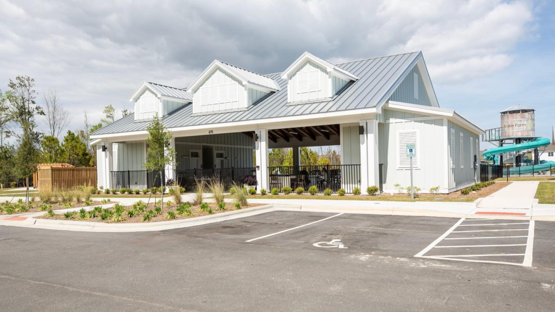 The Amenity Center includes a resort-style pool, clubhouse with kitchen, splash pad, waterslide, playground, pickleball, grill area, outdoor kitchen and fire pit.