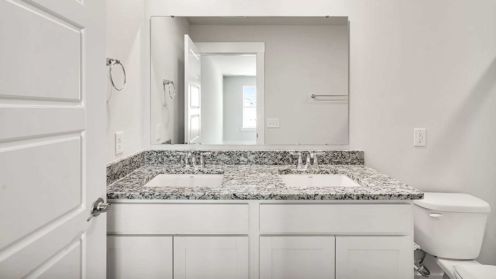 The second floor features the primary bedroom with a walk-in closet and double vanities.
