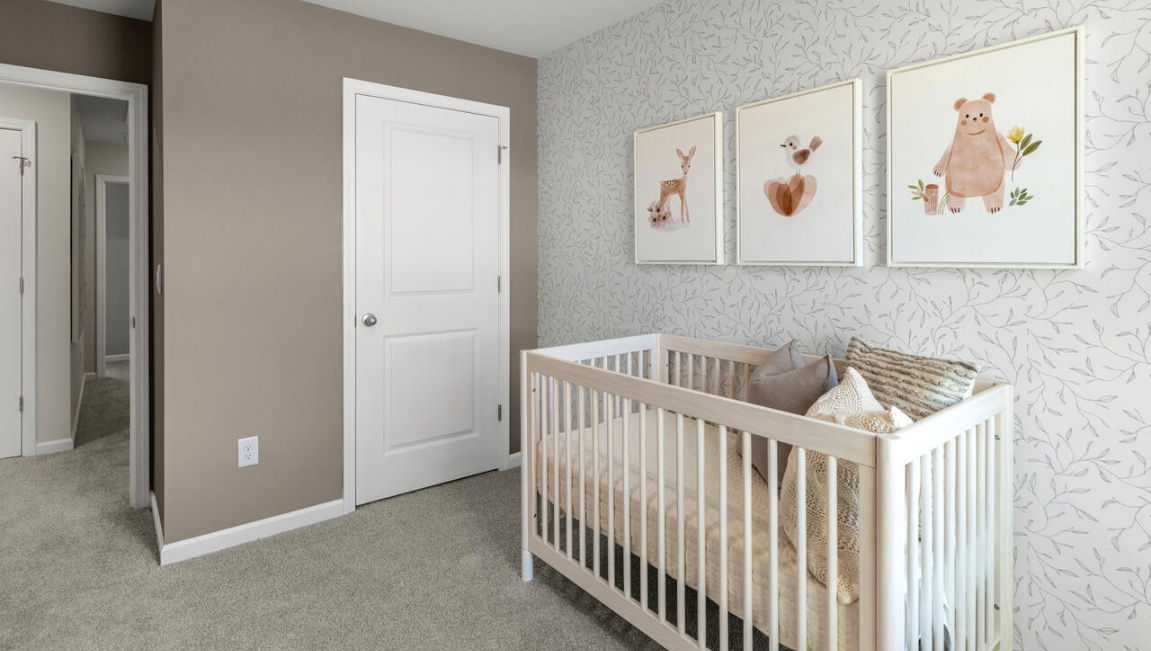The second floor features the primary bedroom with a walk-in closet and double vanities. It also includes two additional bedrooms, a shared bathroom, and a laundry room for convenience.