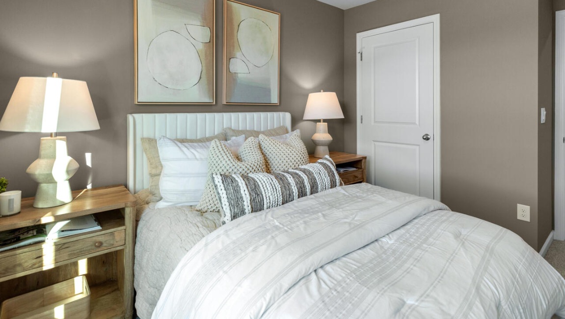 The second floor features the primary bedroom with a walk-in closet and double vanities. It also includes two additional bedrooms, a shared bathroom, and a laundry room for convenience.