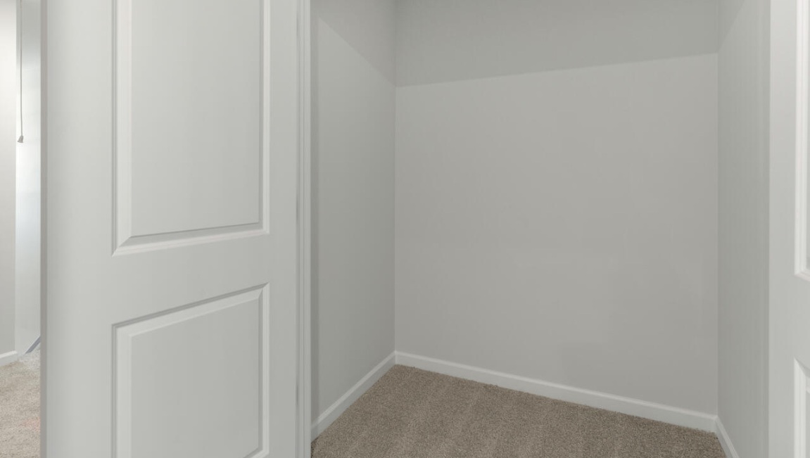 The second floor features the primary bedroom with a walk-in closet and double vanities. It also includes two additional bedrooms, a shared bathroom, and a laundry room for convenience.