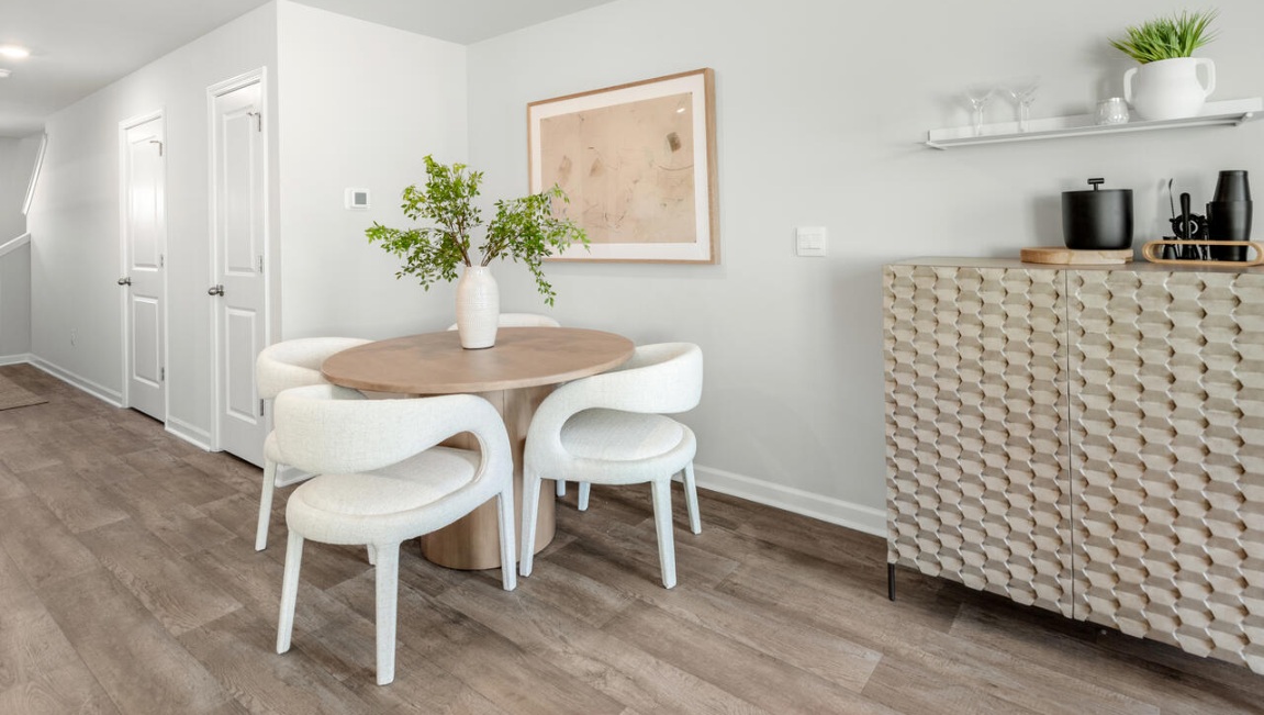 The kitchen overlooks the dining and living spaces, ideal for entertaining guests or enjoying family time while preparing meals with new stainless-steel appliances and granite countertops.