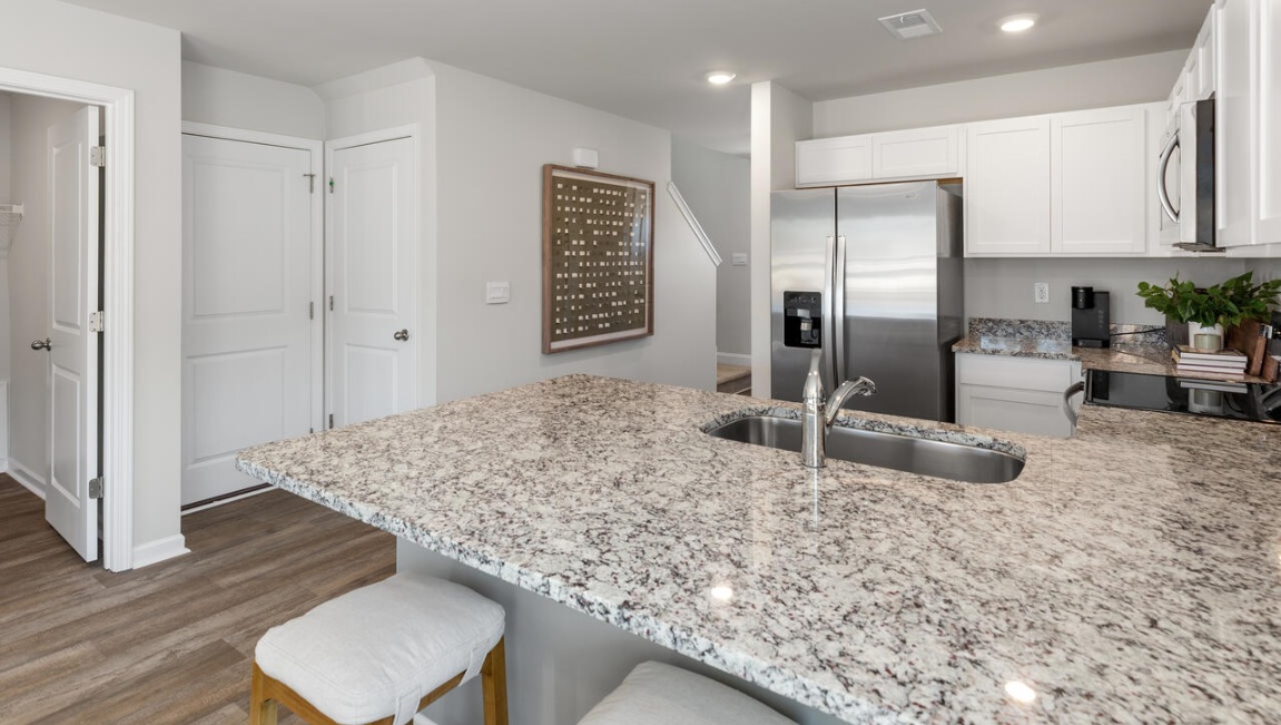 Your new Norman features an open concept first floor anchored by a spacious kitchen with granite countertops, stainless steel appliances and a peninsula bar that overlooks your family and dining room.