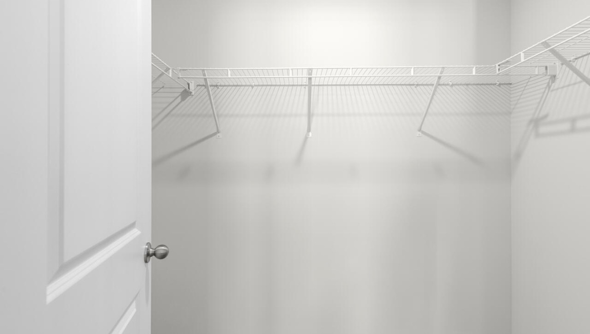 The first floor features the primary bedroom with a walk-in closet and double vanities