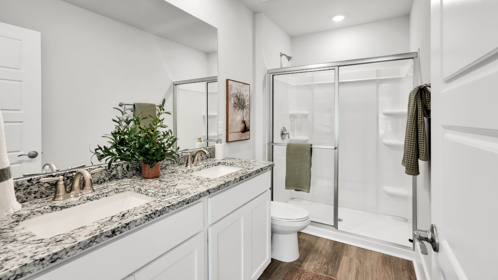 The first floor features the primary bedroom with a walk-in closet and double vanities