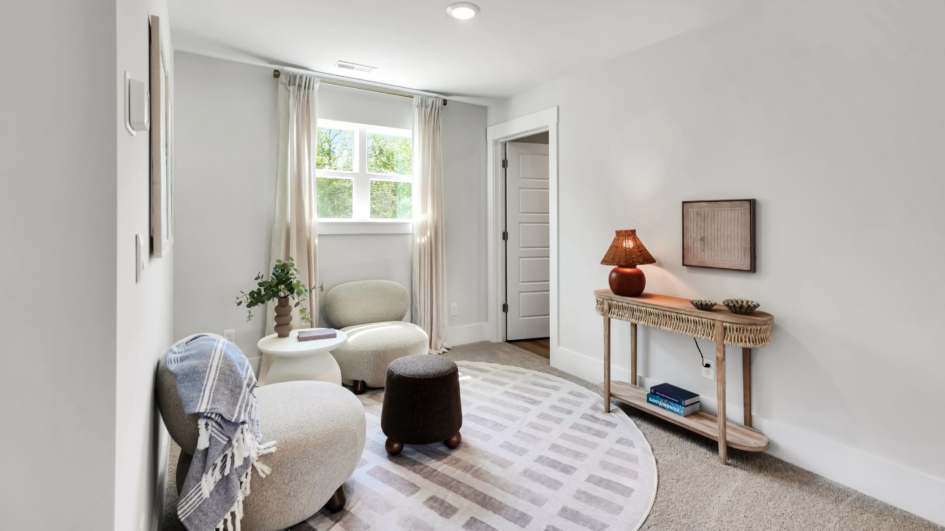 Upstairs there are 3 more bedrooms, a shared bathroom and a loft area, adding to the flexibility of the layout. For those in search of a contemporary townhome with a functional layout, the Norman is an excellent choice.