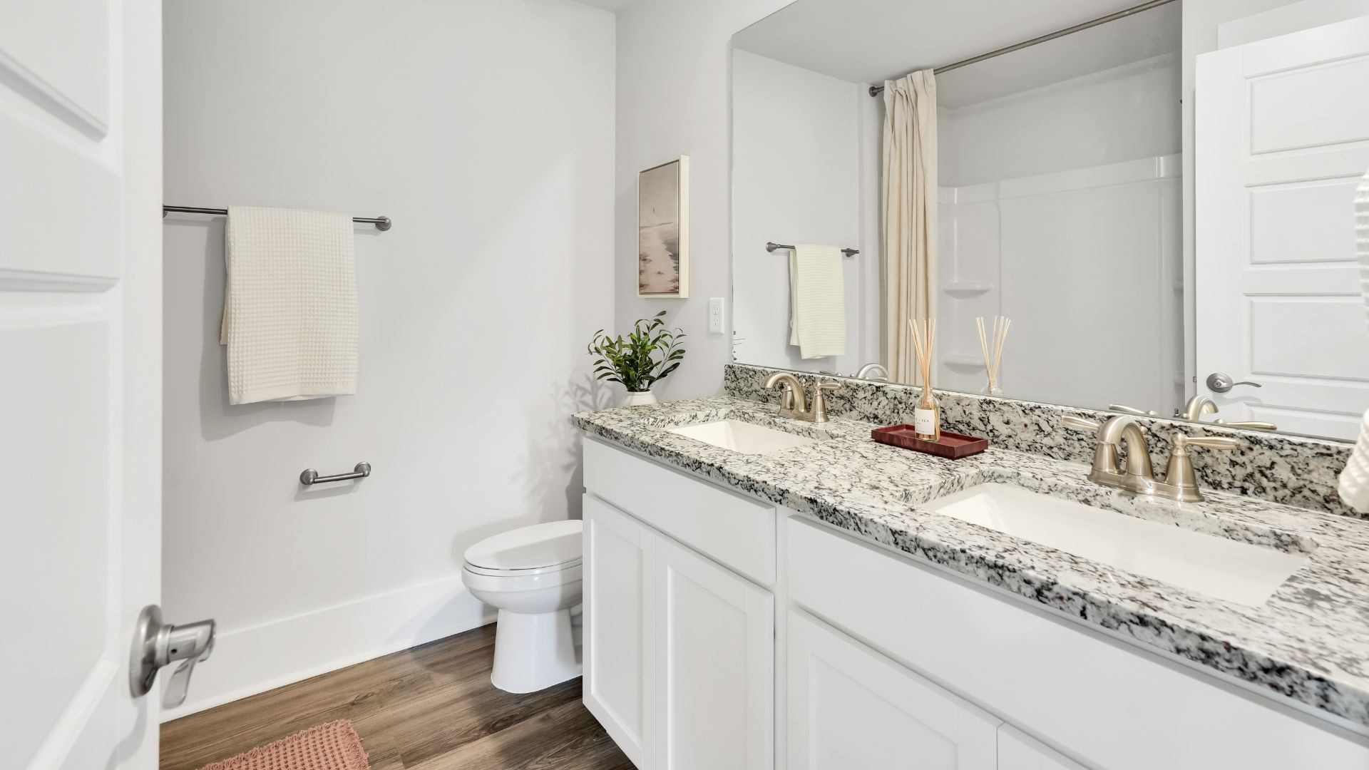 Upstairs there are 3 more bedrooms, a shared bathroom and a loft area, adding to the flexibility of the layout. For those in search of a contemporary townhome with a functional layout, the Norman is an excellent choice.