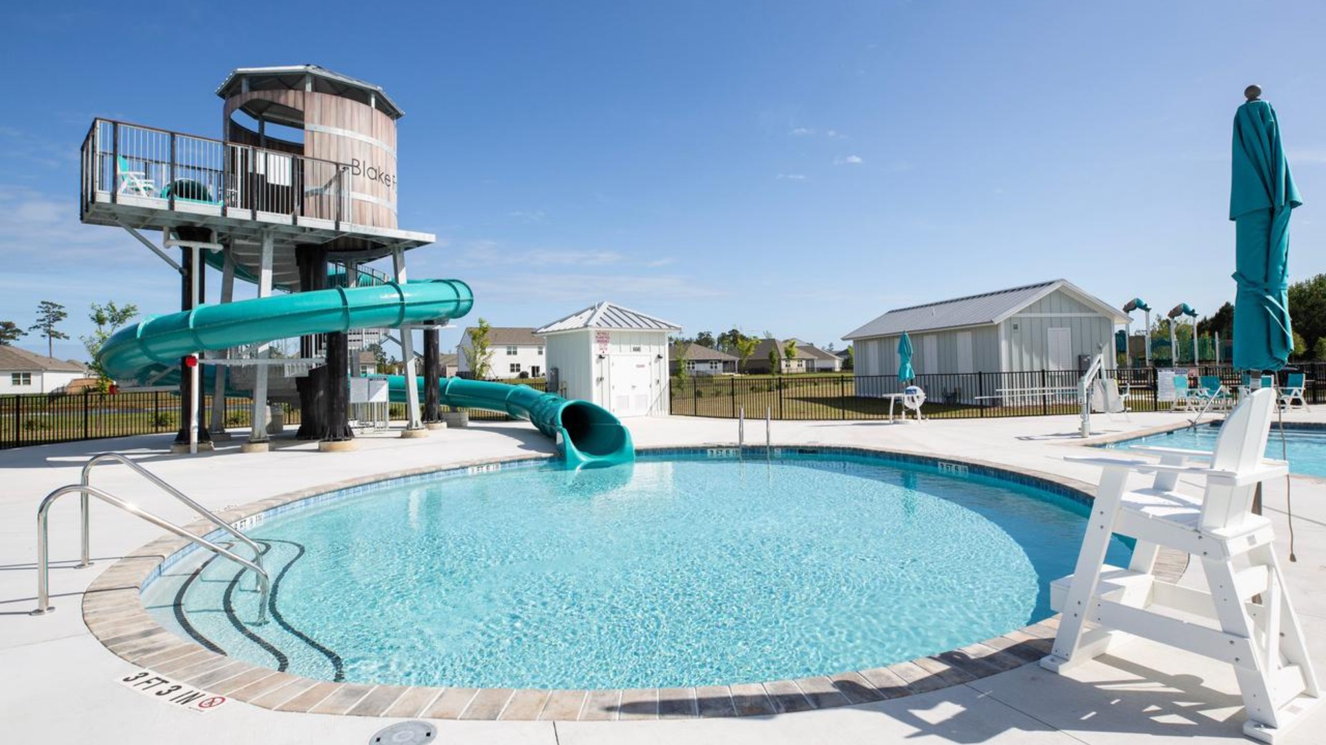 The amenity center that includes a swimming pool, multi-sport court, splashpad, playground, and fire pit, ensuring a well-rounded and enjoyable living experience.