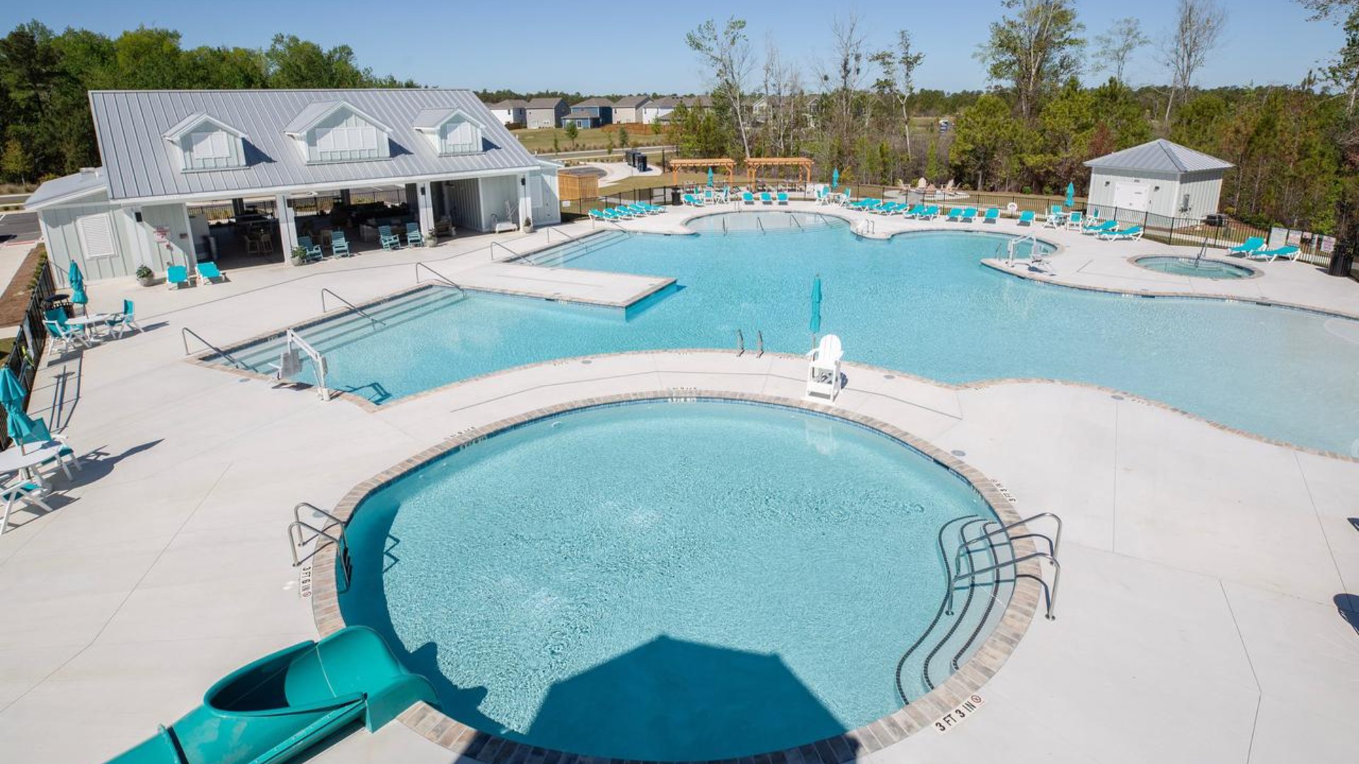 The amenity center that includes a swimming pool, multi-sport court, splashpad, playground, and fire pit, ensuring a well-rounded and enjoyable living experience.