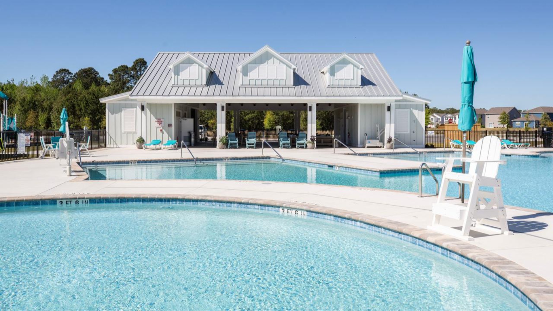 The amenity center that includes a swimming pool, multi-sport court, splashpad, playground, and fire pit, ensuring a well-rounded and enjoyable living experience.