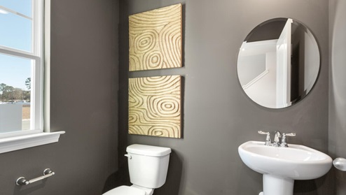 The first floor features the primary bedroom with a walk-in closet and double vanities