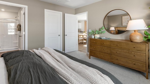 The first floor features the primary bedroom with a walk-in closet and double vanities