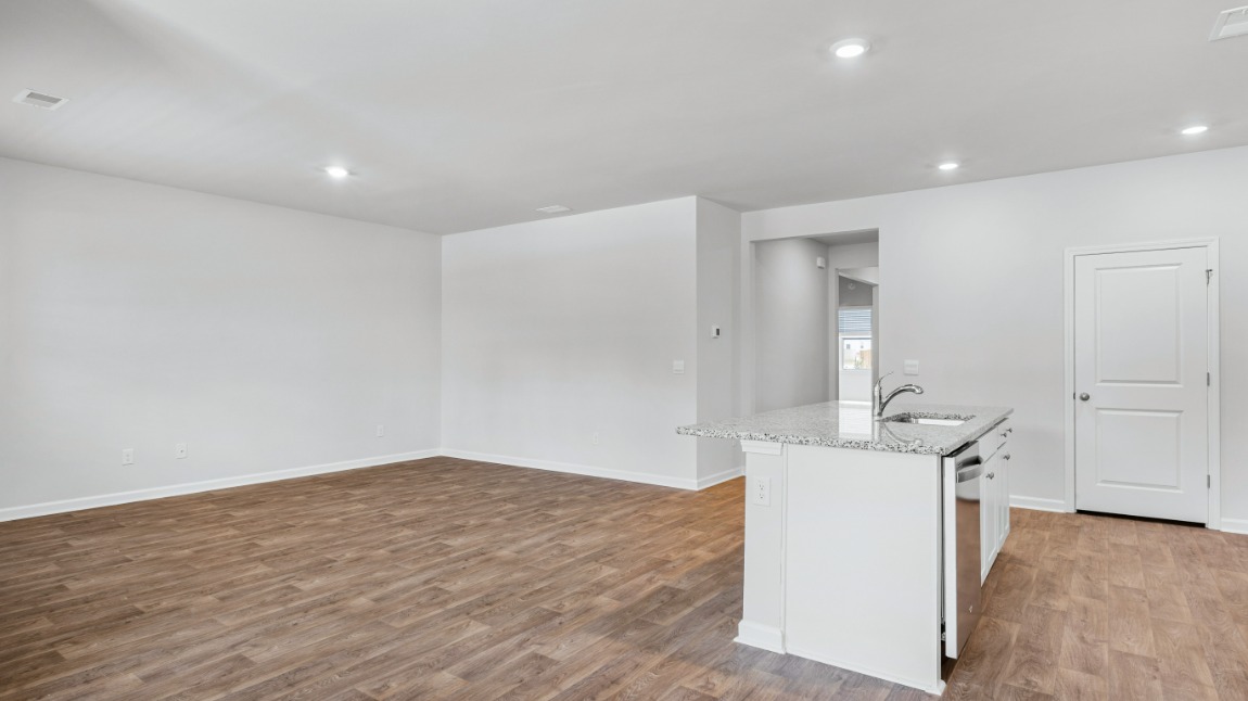 The primary suite is tucked away in the back corner of the home and allows homeowners the privacy to relax and unwind. The primary bedroom boasts a walk-in closet, dual vanity, and separate soaking tub and walk-in shower.