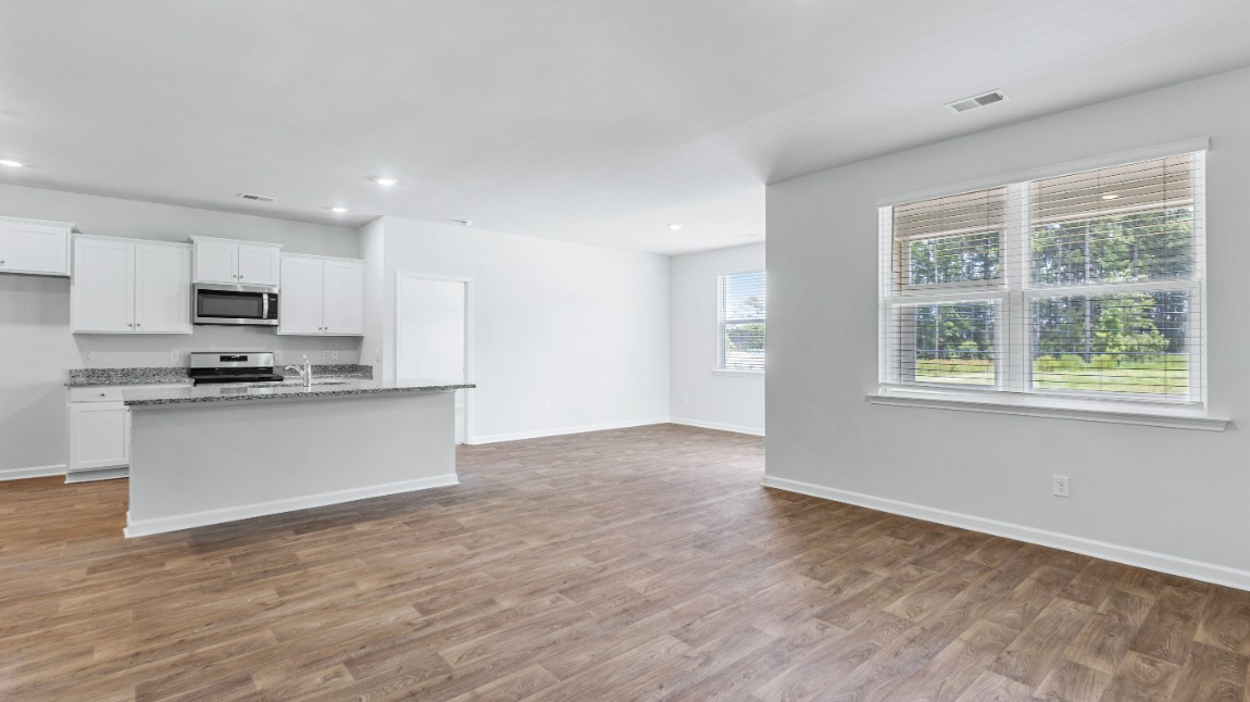 The primary suite is tucked away in the back corner of the home and allows homeowners the privacy to relax and unwind. The primary bedroom boasts a walk-in closet, dual vanity, and separate soaking tub and walk-in shower.