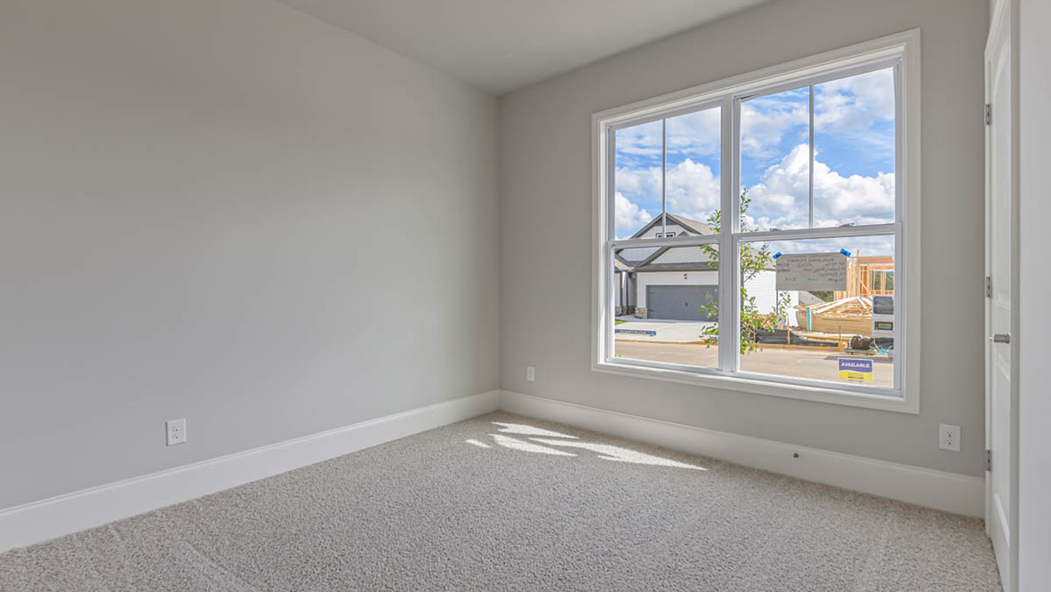 The primary suite serves as a peaceful retreat, featuring an en-suite bathroom with dual vanities and a walk-in closet. The additional bedrooms provide comfort and privacy and share access to a secondary bathroom.