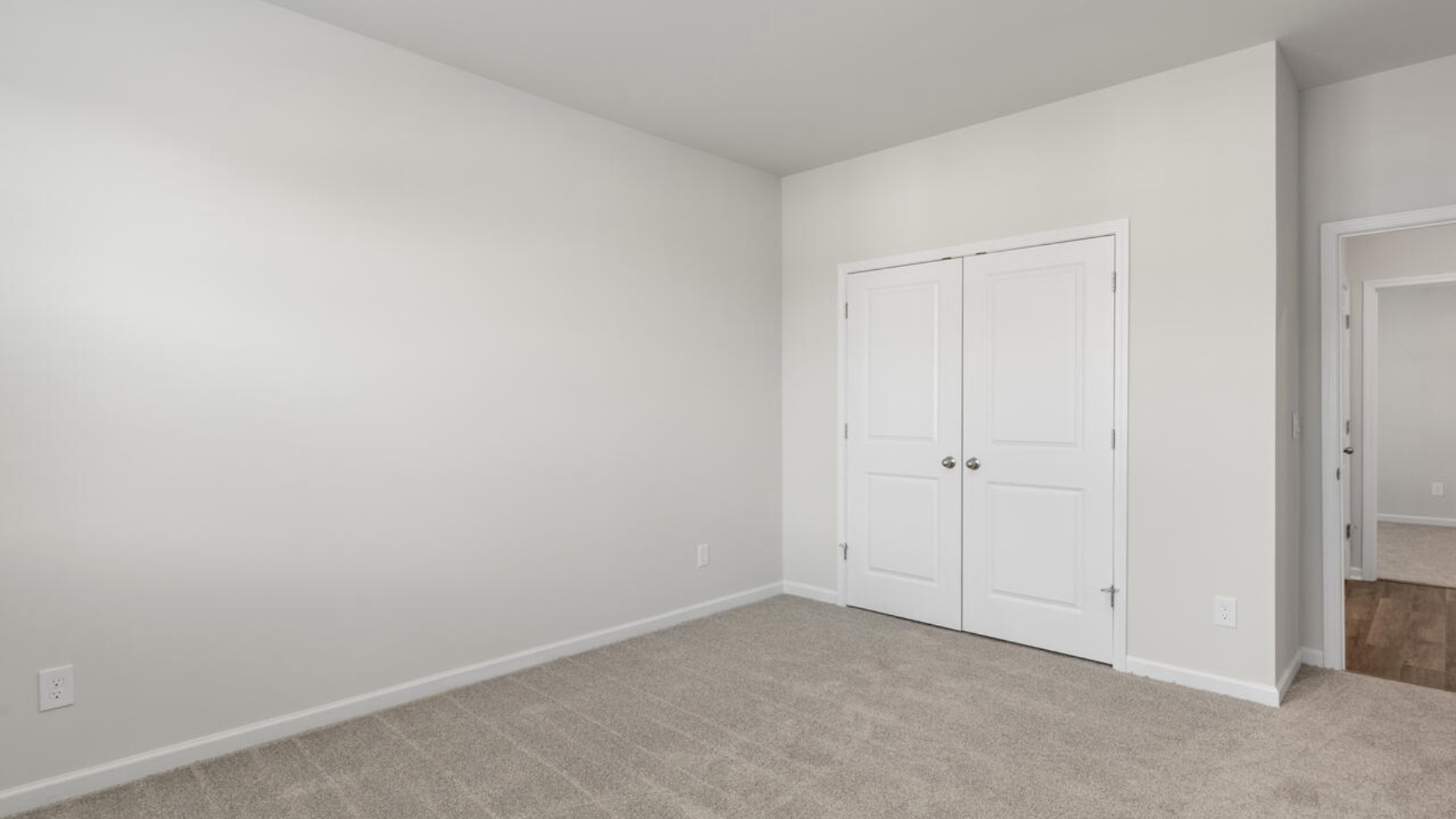 The split bedroom plan creates a private primary bedroom suite featuring two walk-in closets and a spacious en suite bath. There are three bedrooms at the front of the home with a full bathroom as well as laundry room.
