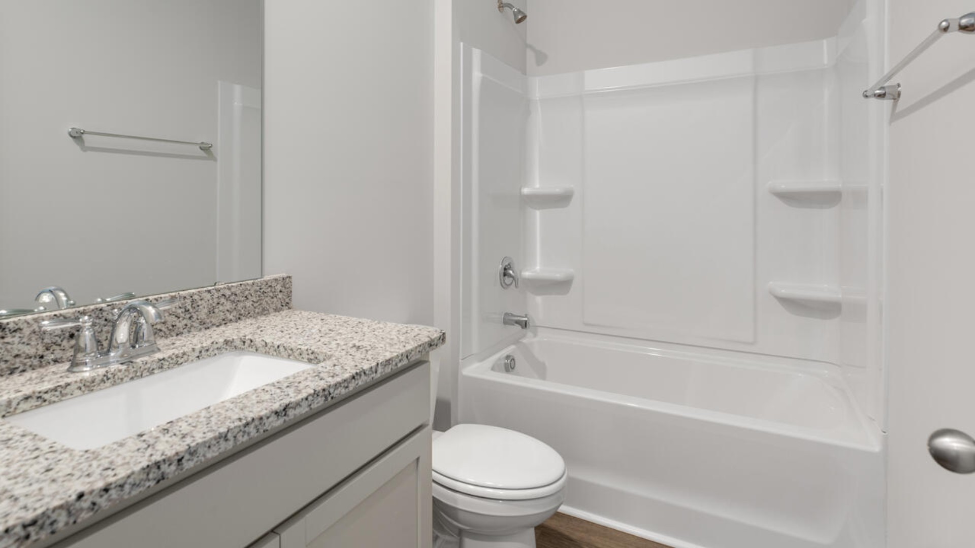 The split bedroom plan creates a private primary bedroom suite featuring two walk-in closets and a spacious en suite bath. There are three bedrooms at the front of the home with a full bathroom as well as laundry room.